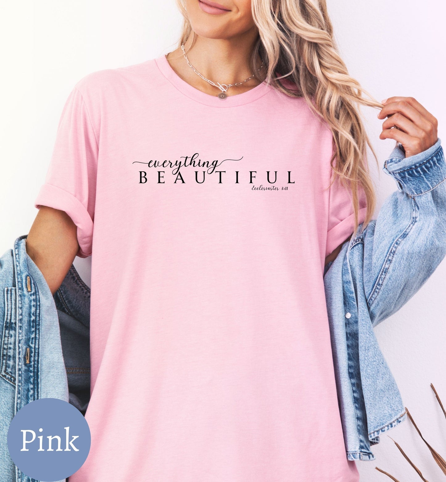 a woman wearing a pink shirt and denim jacket