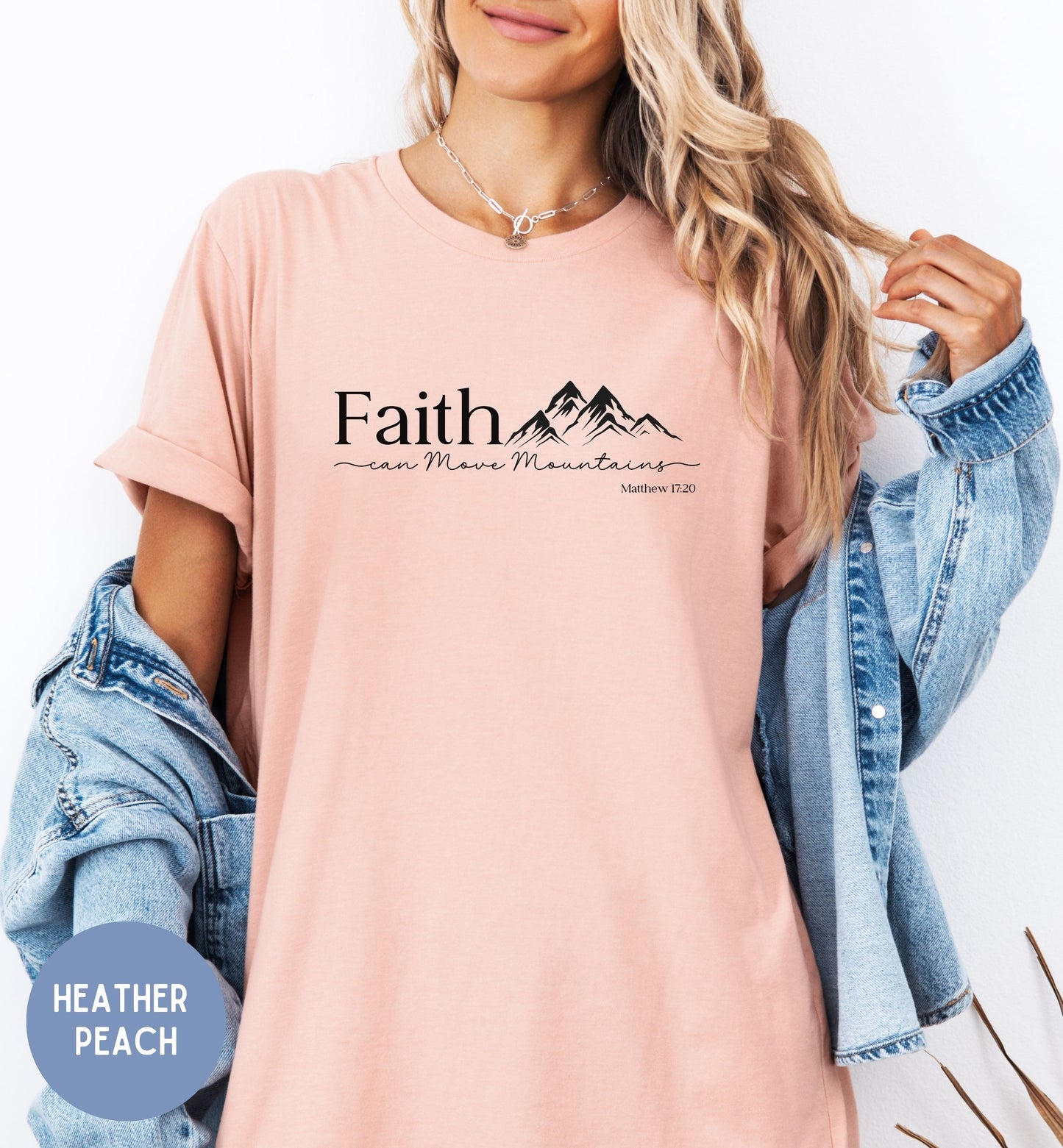 a woman wearing a pink faith t - shirt