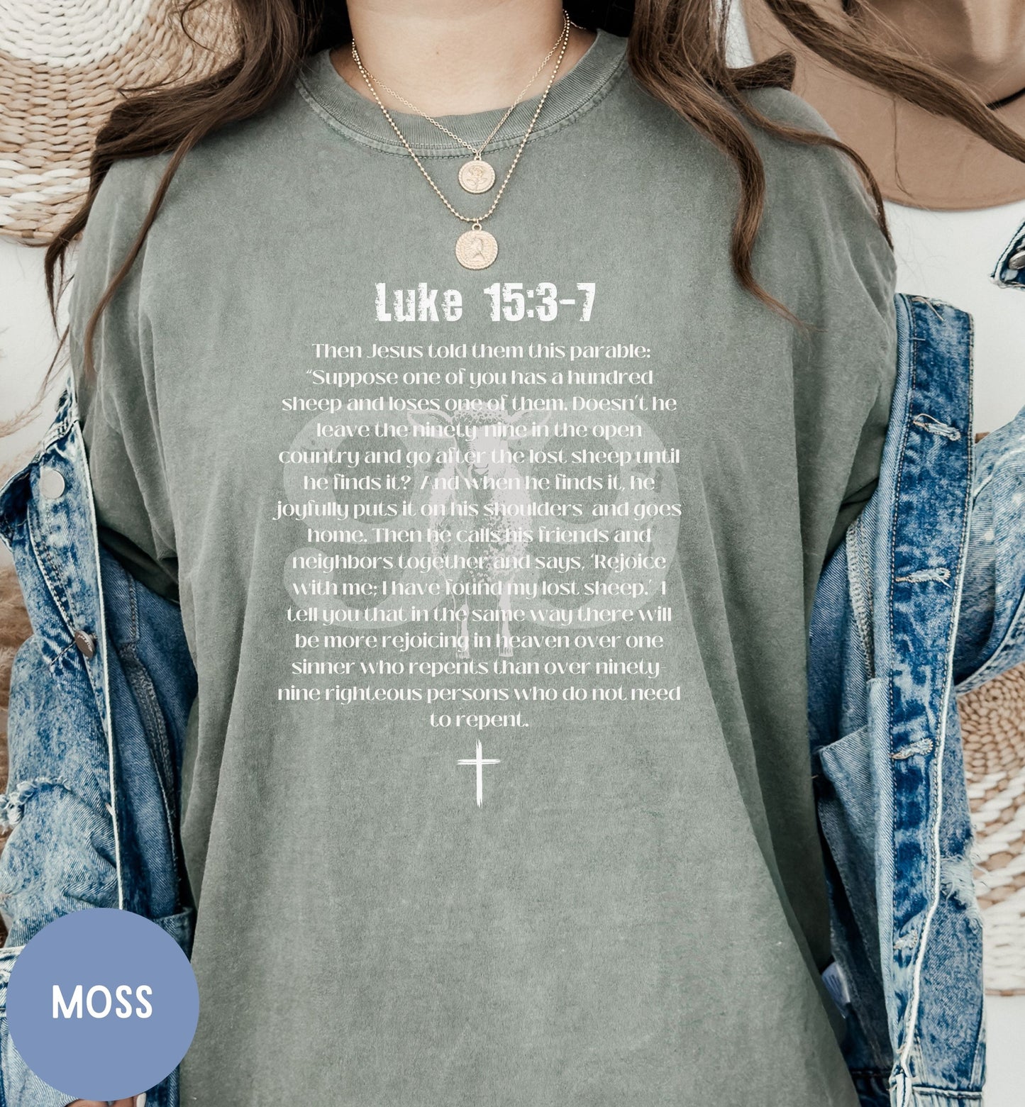 a woman wearing a green shirt with a cross on it