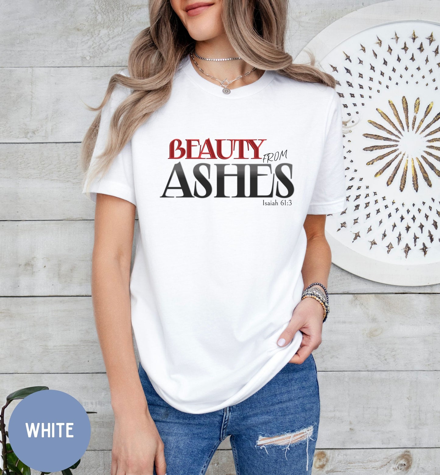 a woman wearing a white t - shirt with the words beauty and ashes on it
