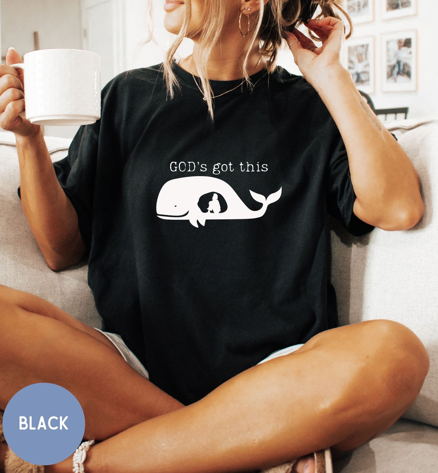 a woman sitting on a couch holding a cup of coffee