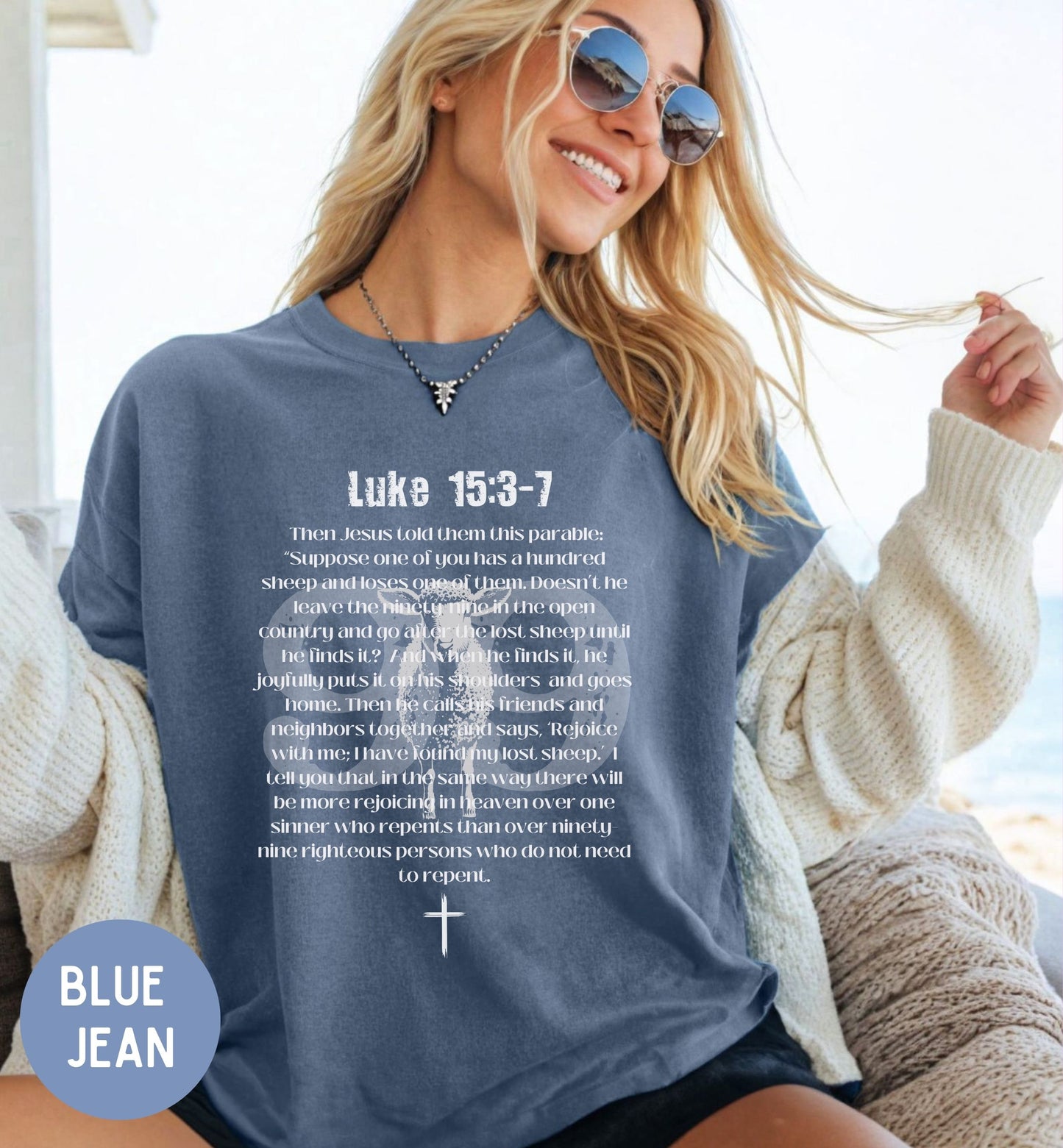 a woman sitting on a couch wearing a blue jean shirt