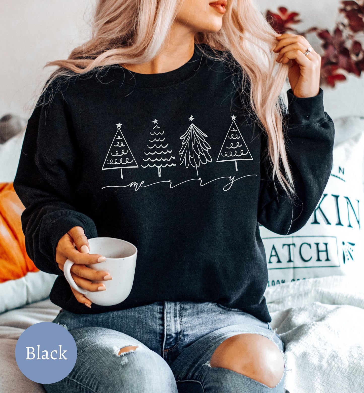a woman sitting on a couch holding a cup of coffee