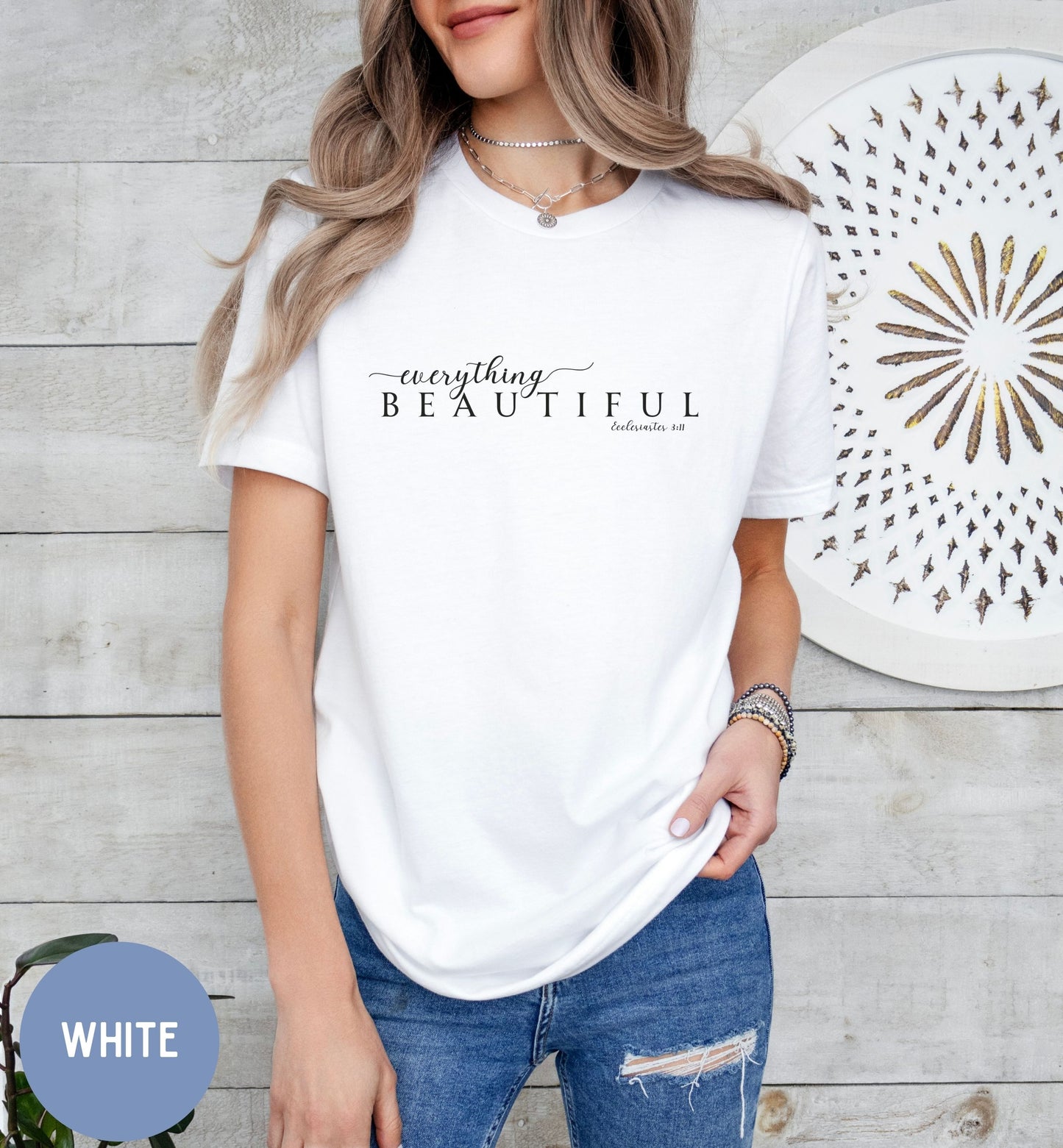 a woman wearing a white t - shirt with the words beautiful written on it
