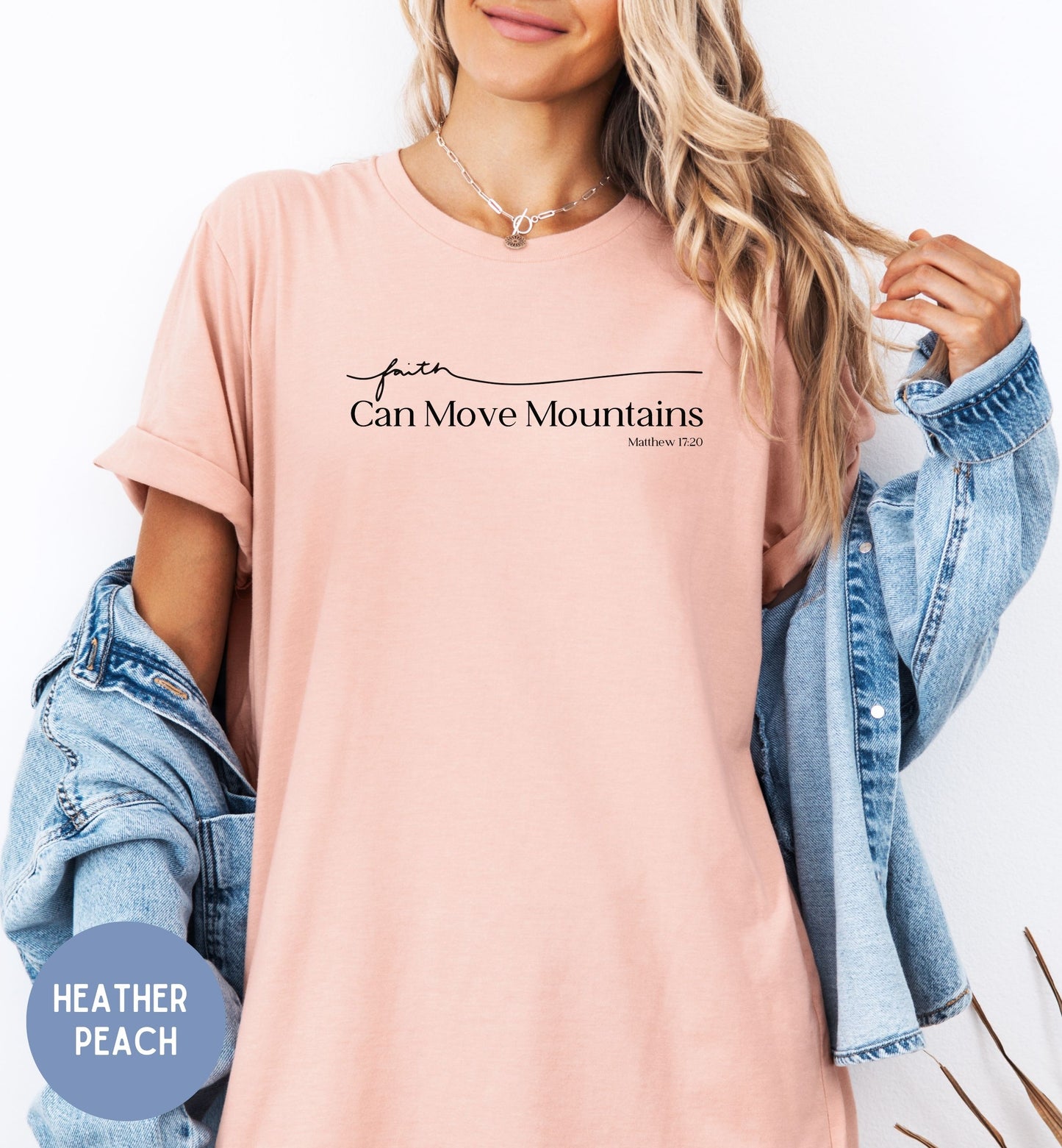 a woman wearing a pink shirt that says can move mountains
