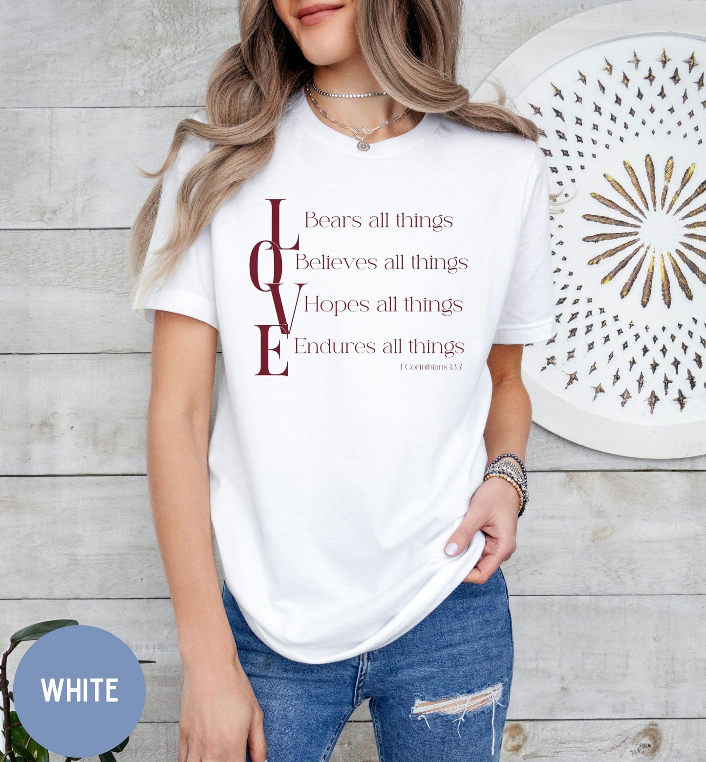 a woman wearing a white t - shirt with the words love on it
