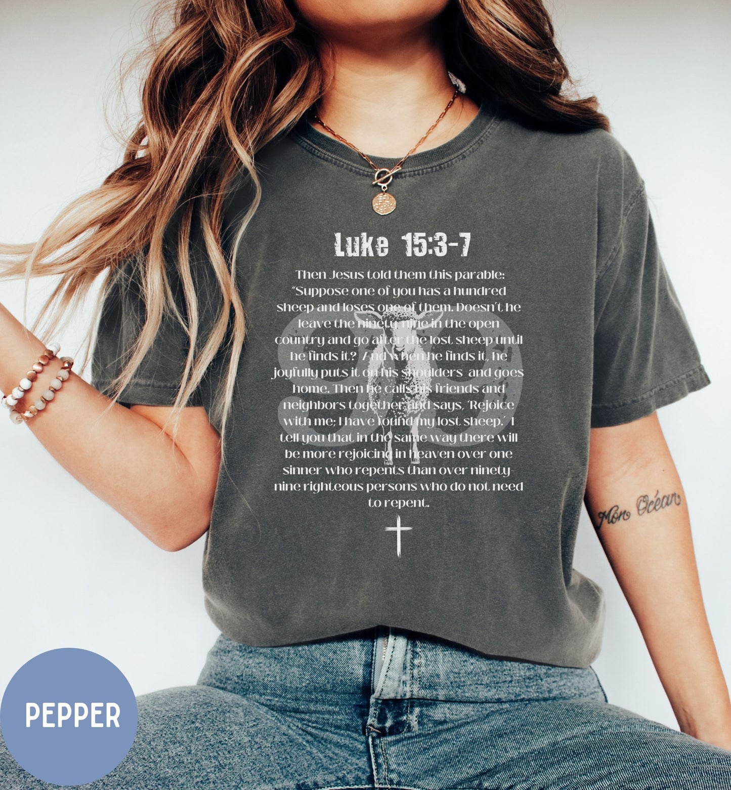 a woman wearing a t - shirt with a cross on it