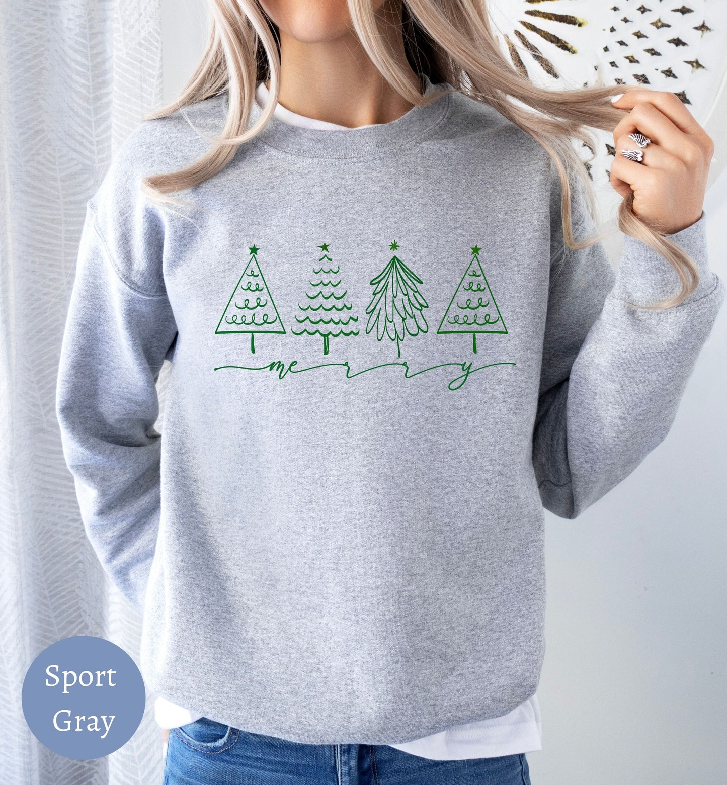 a woman wearing a sweatshirt with christmas trees on it