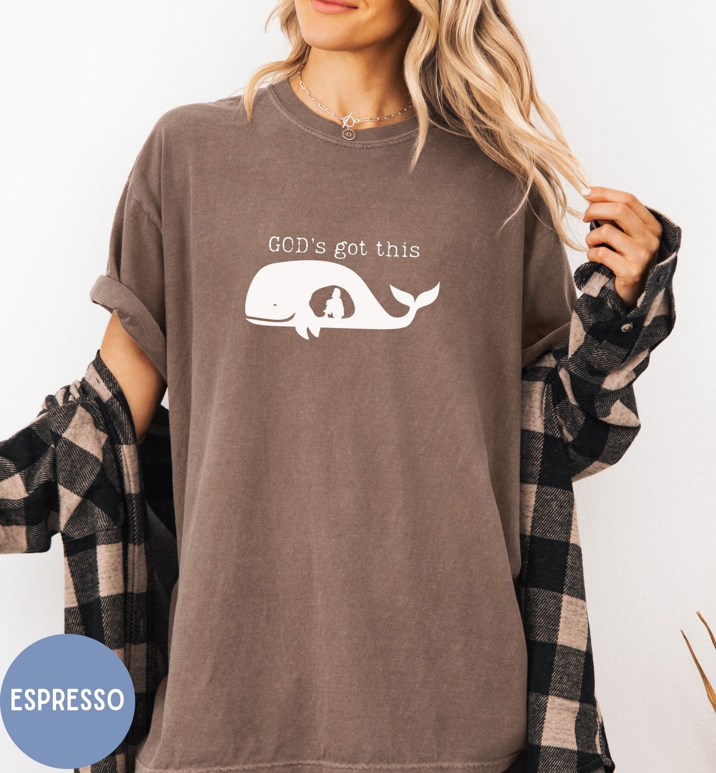 a woman wearing a brown shirt that says god's got this