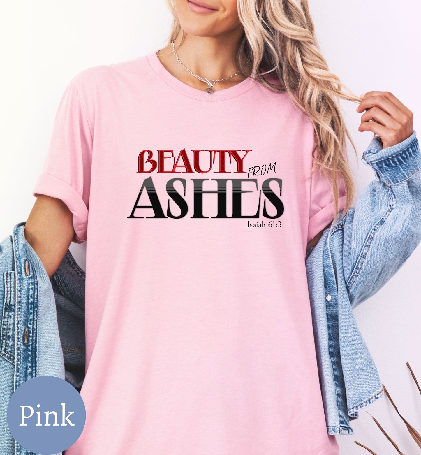a woman wearing a pink t - shirt that says beauty from ashes