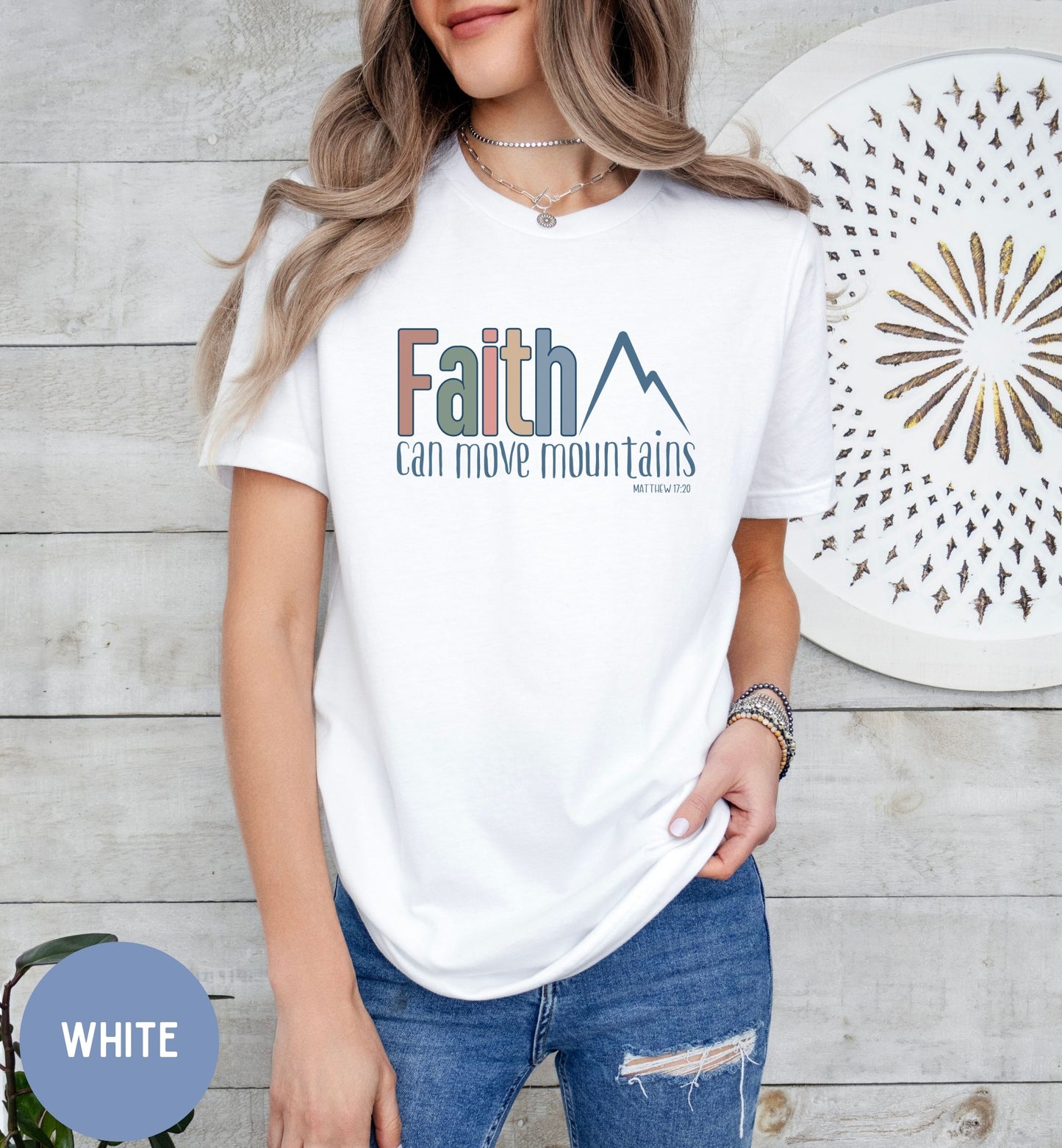 a woman wearing a t - shirt that says faith can move mountains