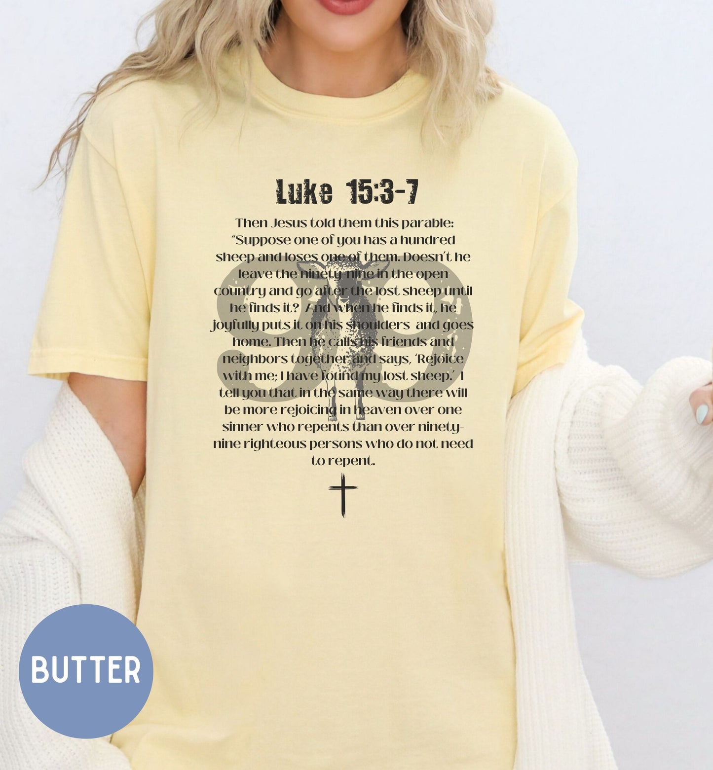 a woman wearing a yellow shirt with a cross on it
