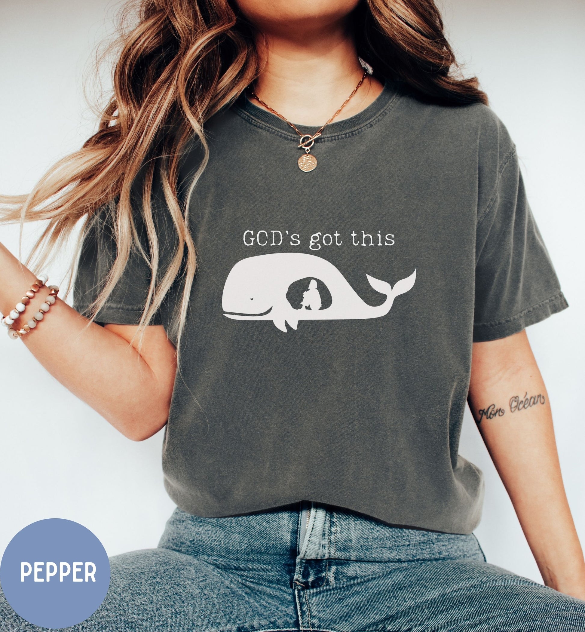 a woman wearing a t - shirt that says god's got this