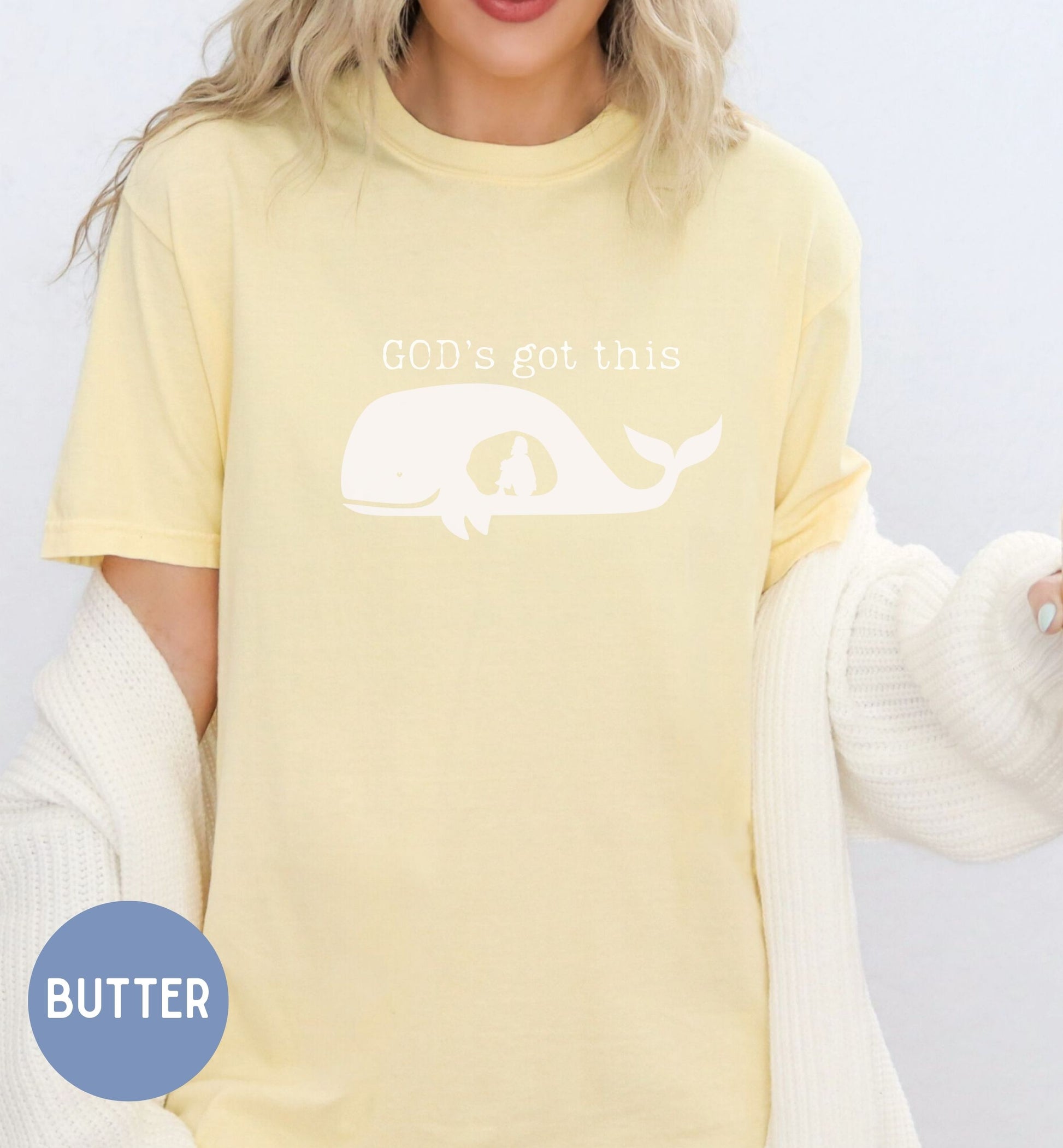 a woman wearing a yellow shirt with a whale on it