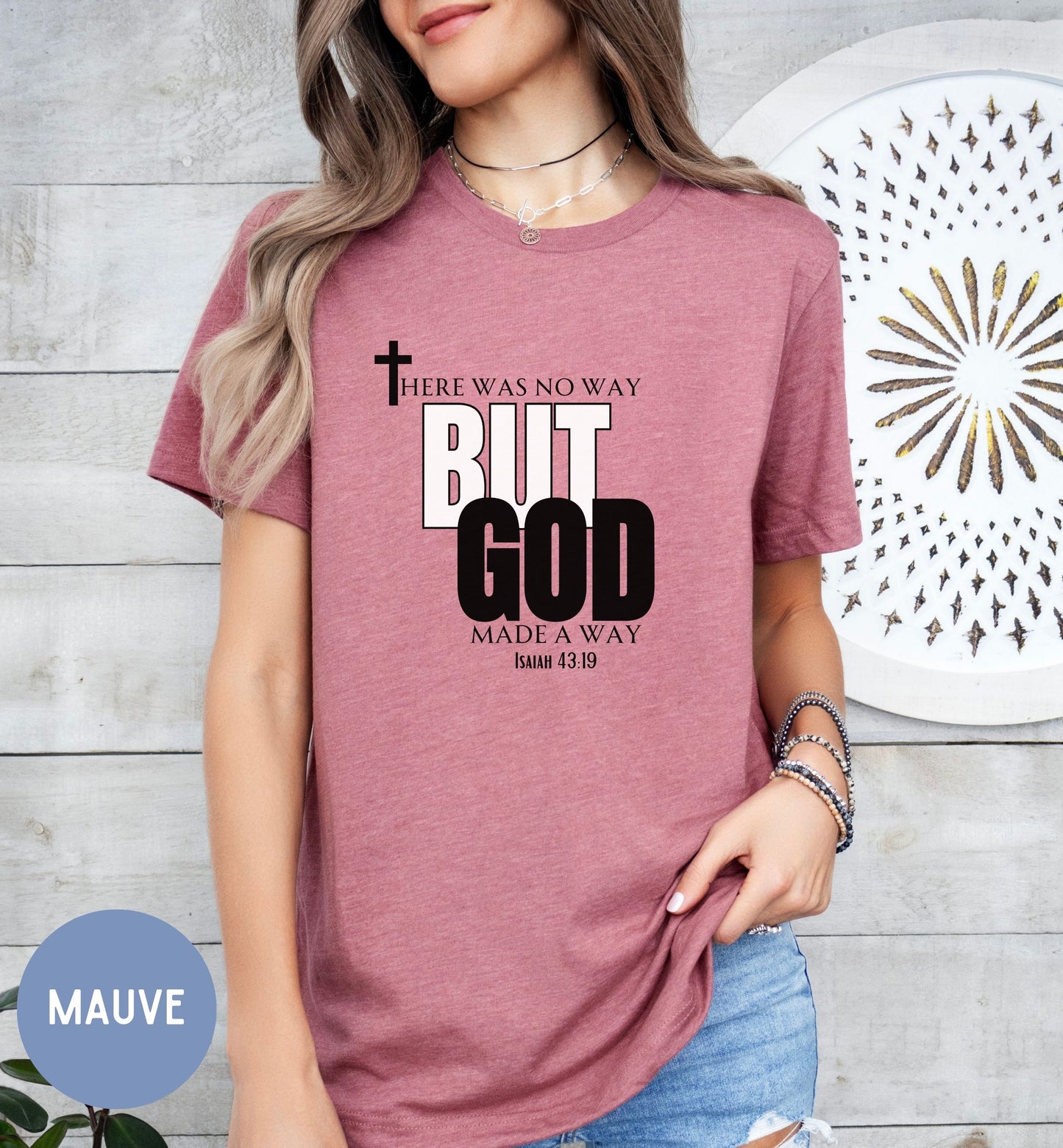 a woman wearing a t - shirt with the words, but god made a way