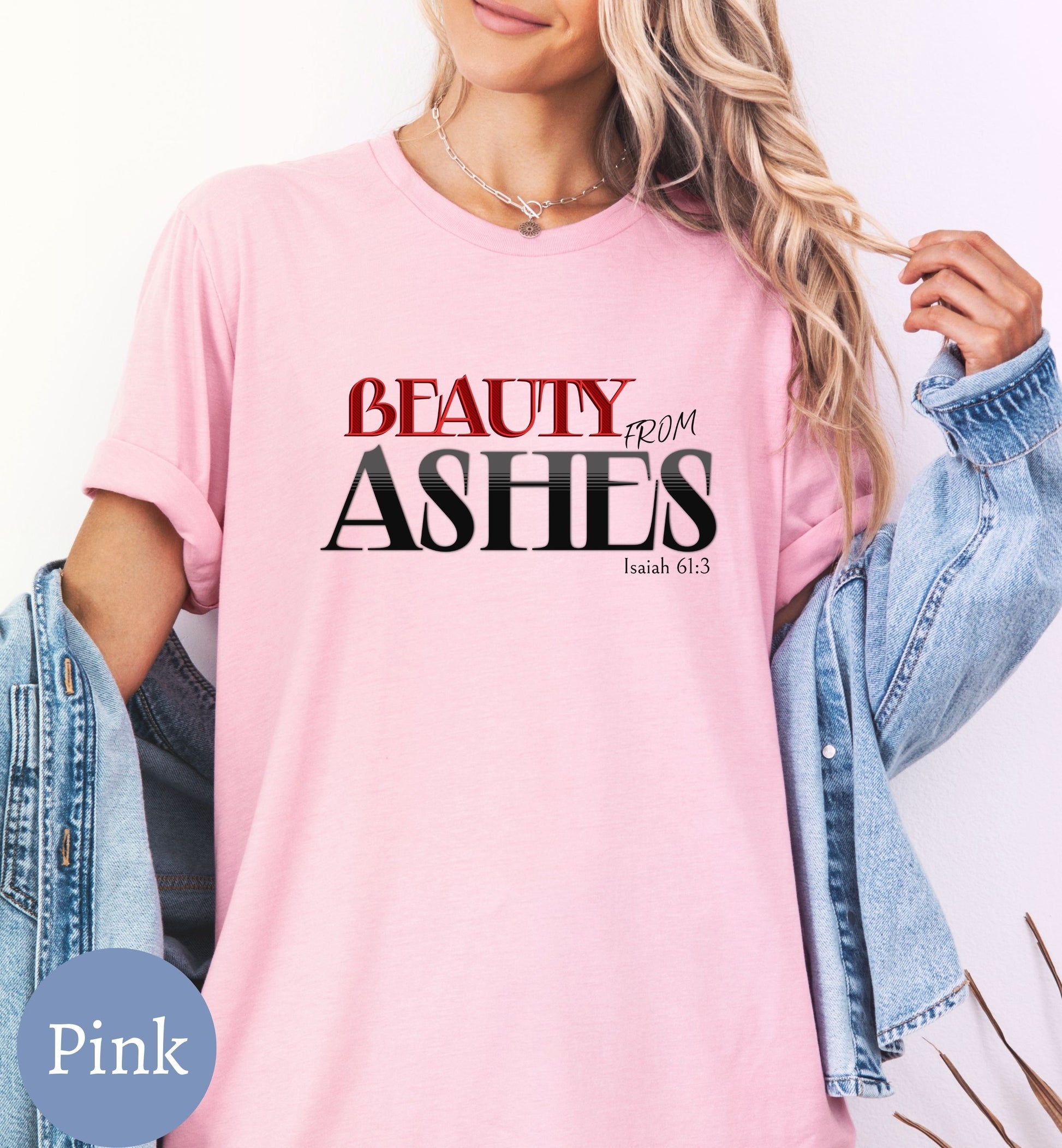 a woman wearing a pink t - shirt that says beauty from ashes