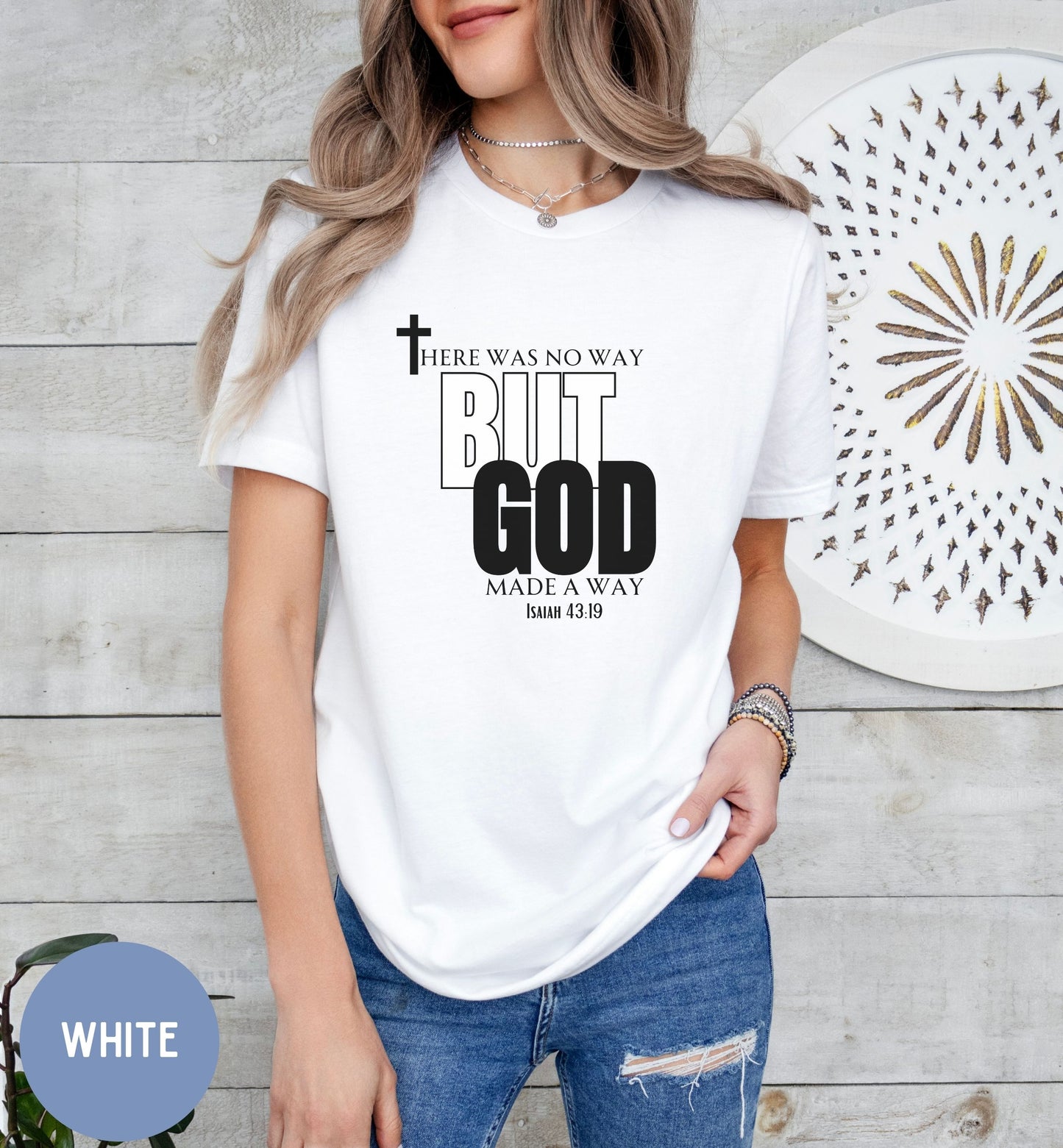 a woman wearing a white t - shirt with a cross on it