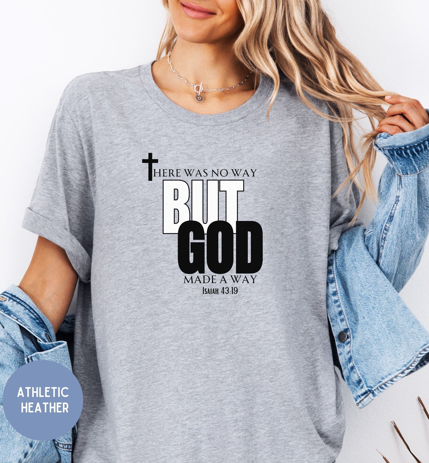 a woman wearing a grey t - shirt that says, but god made a way