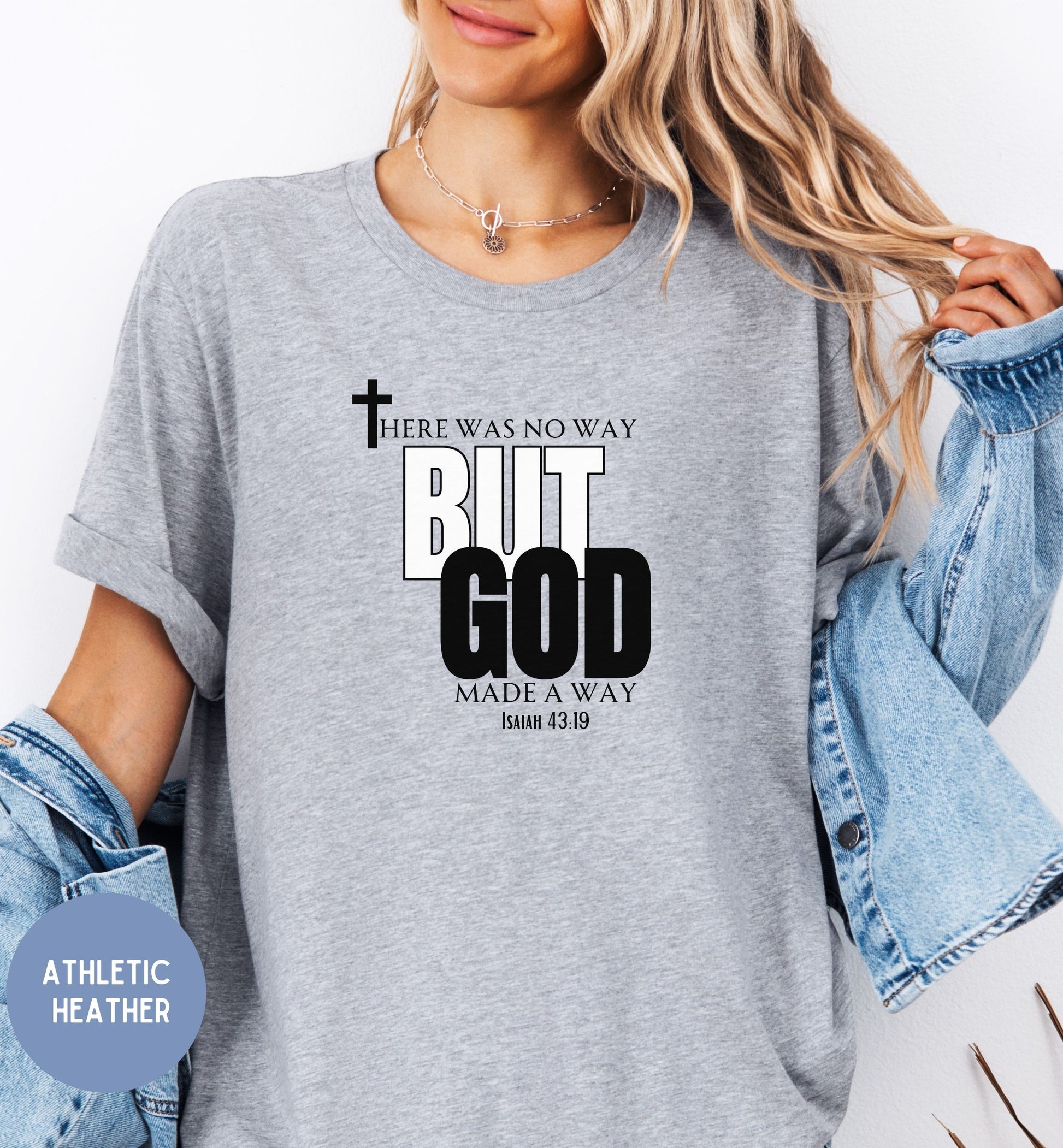 a woman wearing a grey t - shirt that says, but god made a way