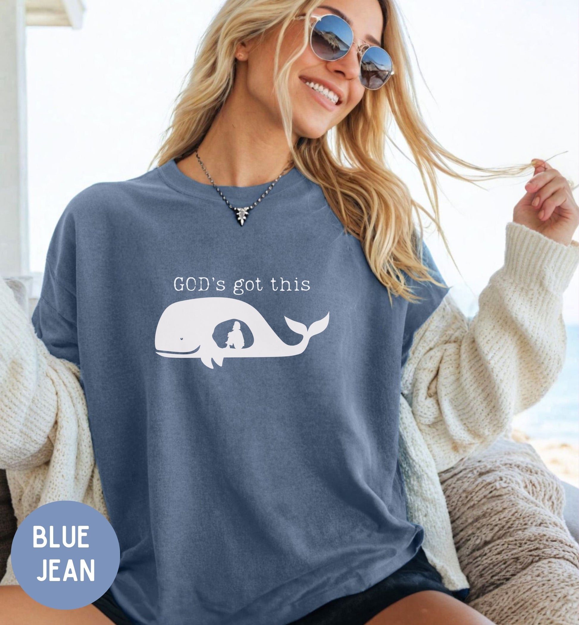 a woman wearing a blue shirt that says god's got this