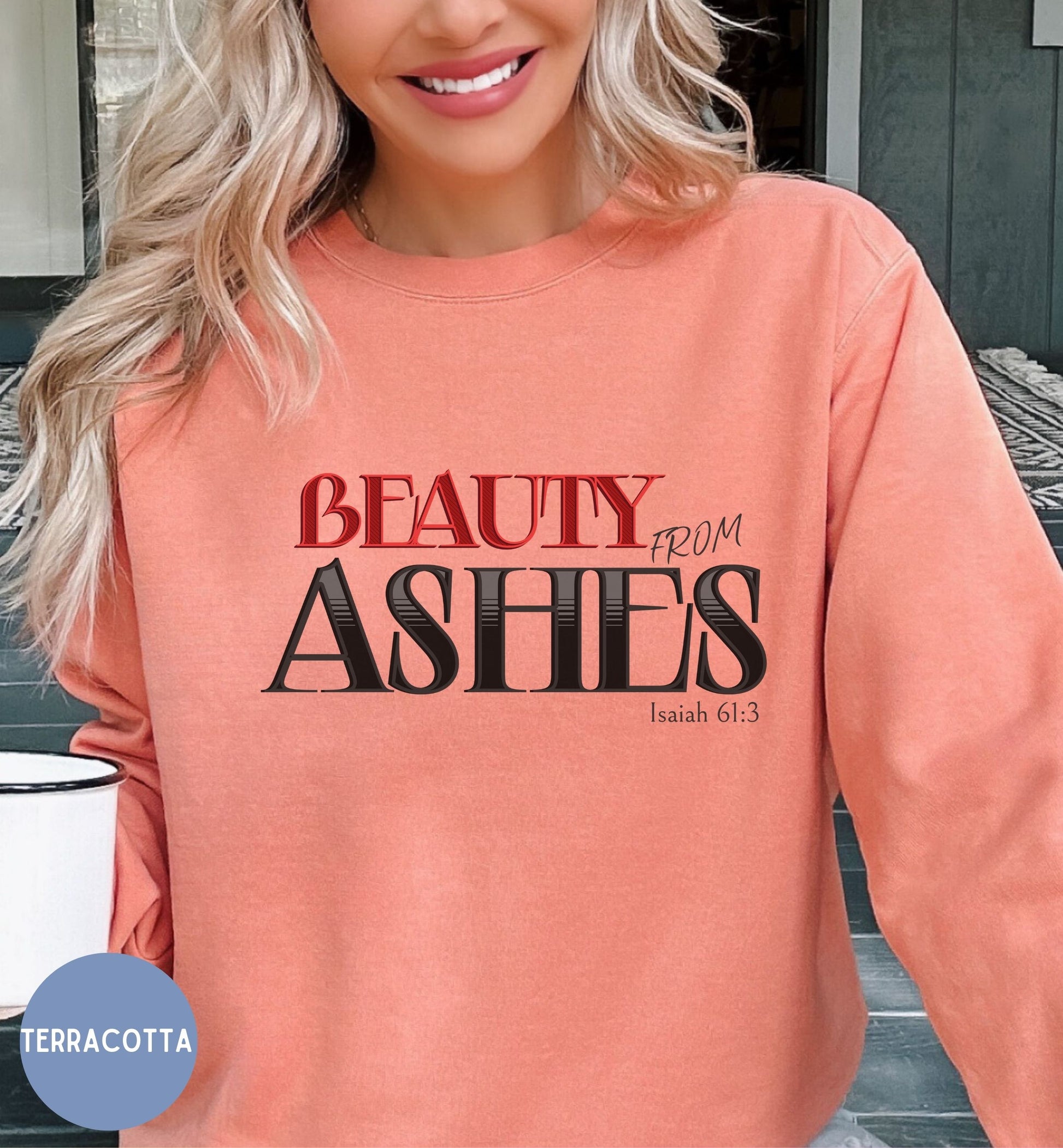 a woman with blonde hair wearing an orange sweatshirt